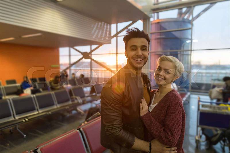 Young Couple In Airport Lounge Waiting Departure Happy Smile Hispanic Man And Woman Flight, stock photo