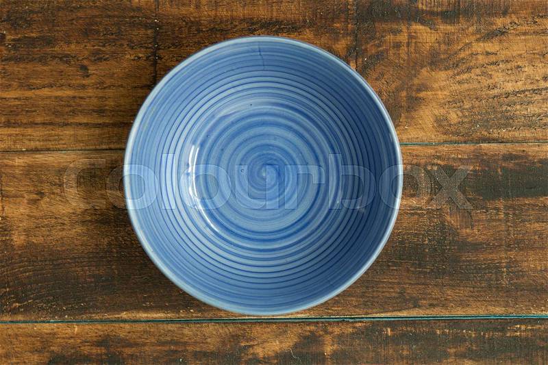 Empty bowl for the kitchen on a wooden background, stock photo