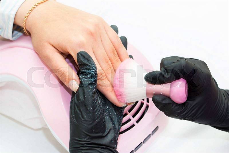 Woman doing manicure beauty salon, stock photo