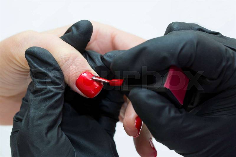 Woman doing manicure beauty salon, stock photo