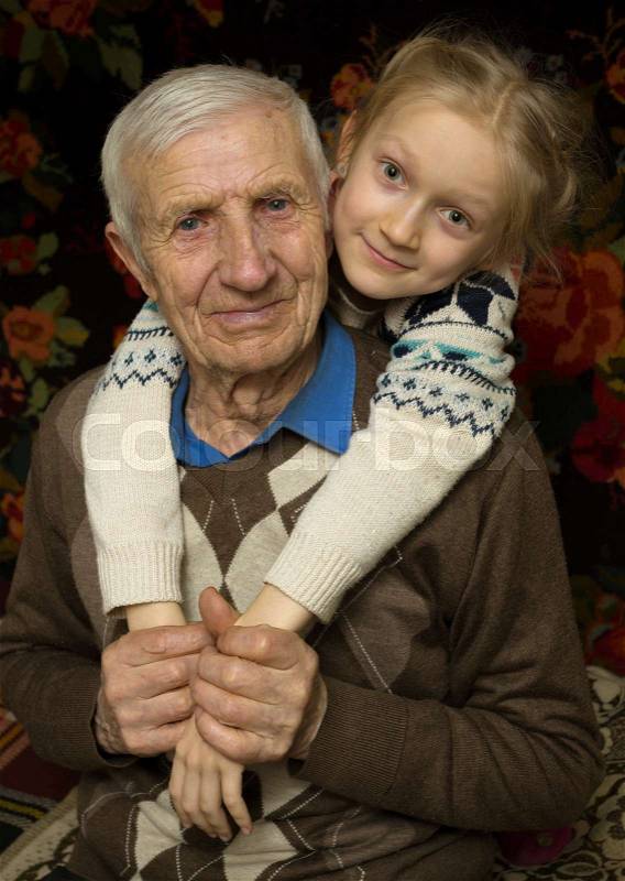 Portrait of smiling senior man and the great-granddaughter , stock photo