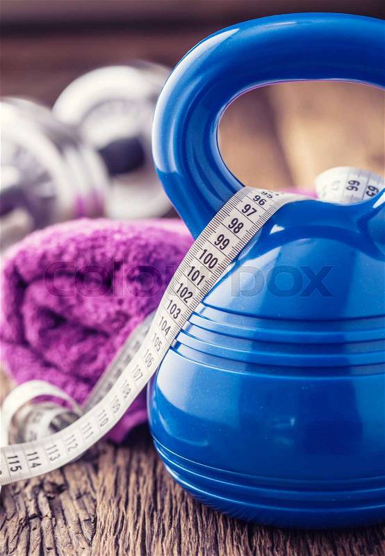 Fitness Equipment. Kettlebell dumbbells towel water and measuring tape, stock photo