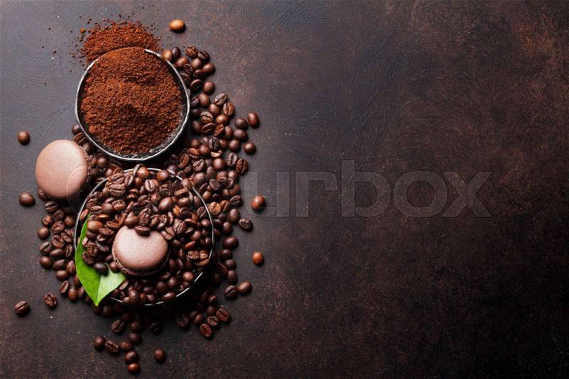 Coffee beans and ground powder on stone background. Top view with copy space for your text, stock photo