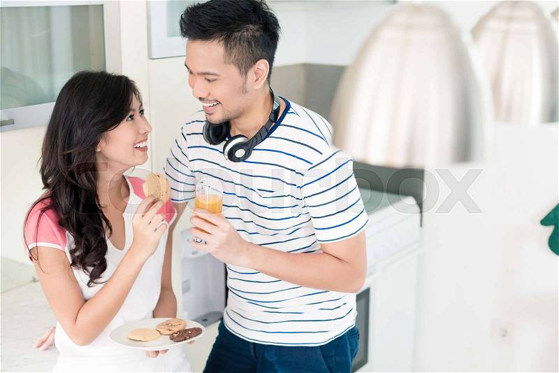 Indonesian woman and man in their kitchen, they are a couple, stock photo