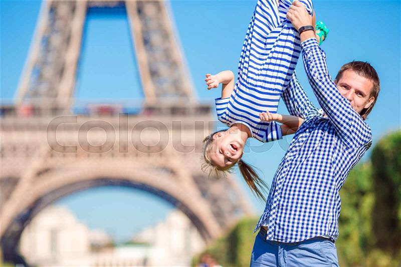 Happy family in Paris background Eiffel Tower on french vacation in Europe, stock photo