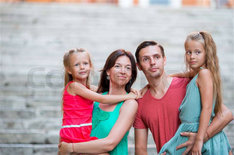 Family of four on european vacation. Airplane in woman hand, stock photo
