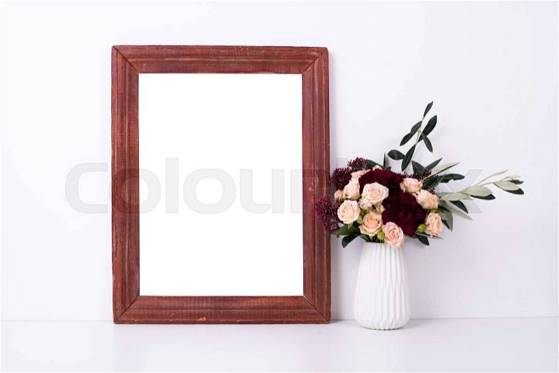 Wooden frame and flowers, home decoration mock-up on white wall background, stock photo