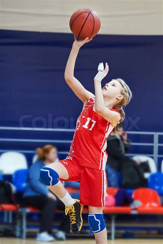 Girl athlete with injury of fingers in sport uniform playing basketball, stock photo