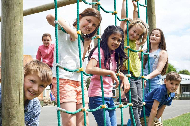 Portrait Of School Pupils Playing On Climbing Frame, stock photo