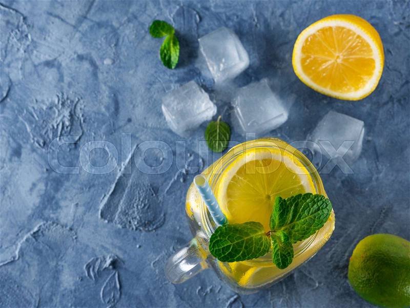 Lemonade with mint in mason jar on blue concrete background. Summer drink. Top view or flat lay. Copy space, stock photo