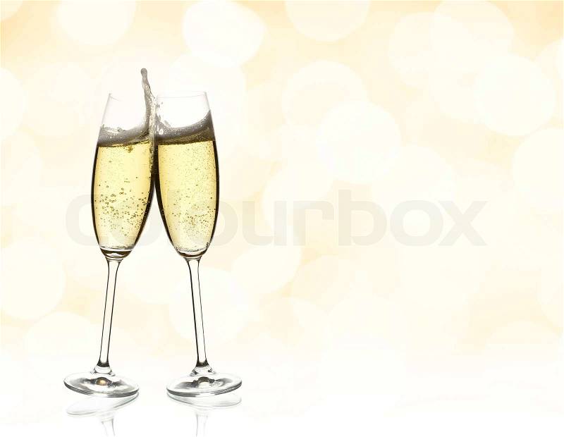 Two glasses of sparkling wine with copyspace and abstract lights background, stock photo