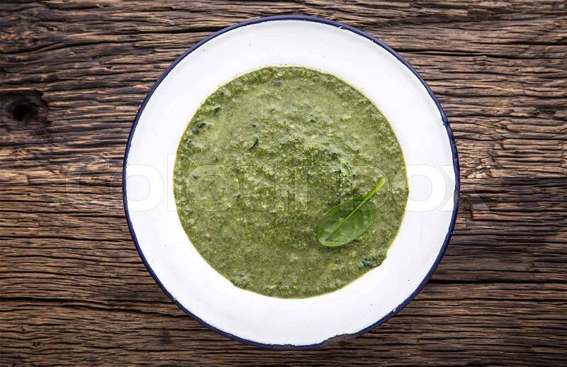Spinach soup. Portion spinach soup with egg and cheese parmesan in retro style, stock photo