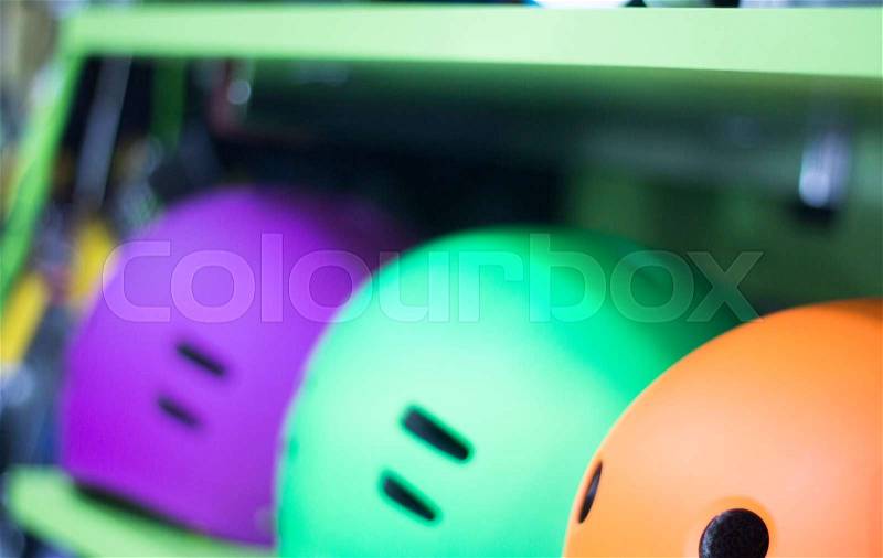 Inline and quad roller skates helmets head protection in retail skate shop display on sale, stock photo
