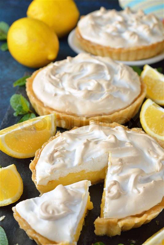 Lemon pie with meringue on a blue background, stock photo