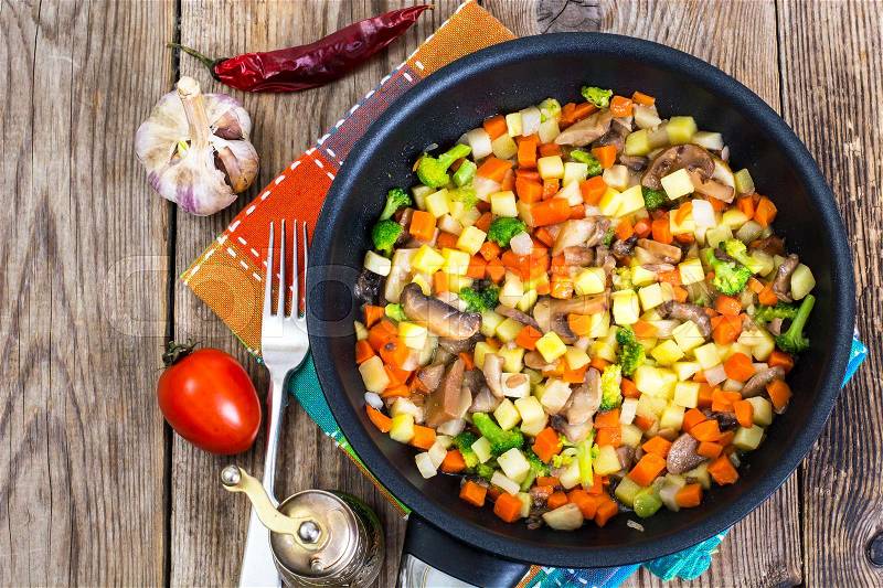 Vegetables with mushrooms, cooked in frying pan. Studio Photo, stock photo