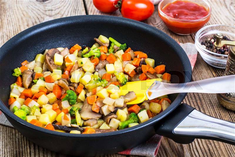 Vegetables with mushrooms, cooked in frying pan. Studio Photo, stock photo