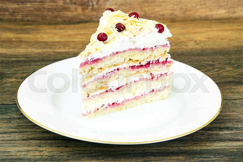 Piece of sponge cake with berries and cream. Studio Photo, stock photo