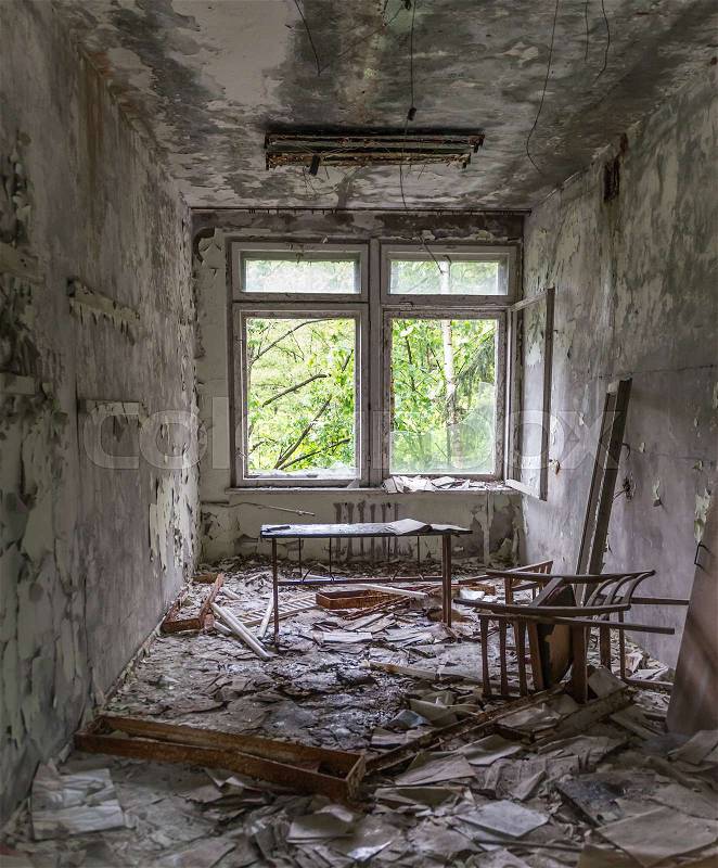 Abandoned school study with debris and broken furniture in Pripyat, stock photo