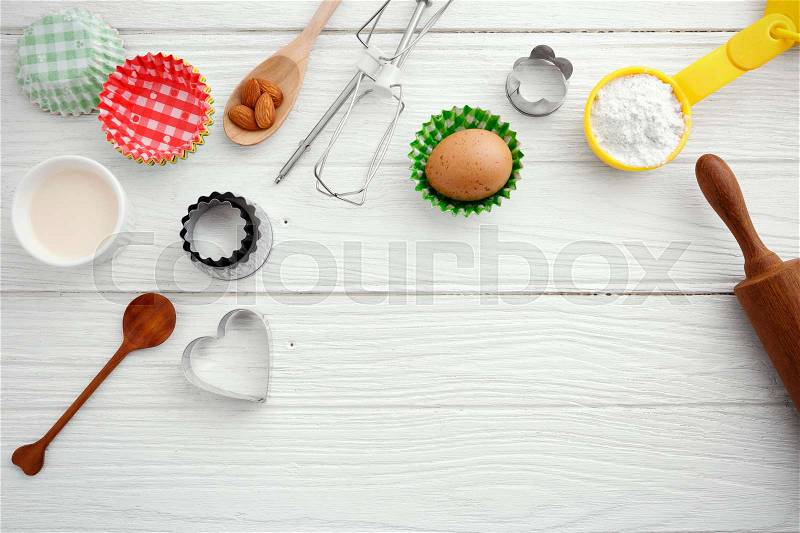 Baking background with baking ingredients and tool on wooden table, stock photo