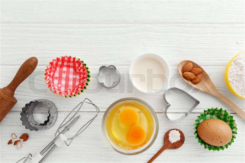 Baking background with baking ingredients on white wooden table, stock photo