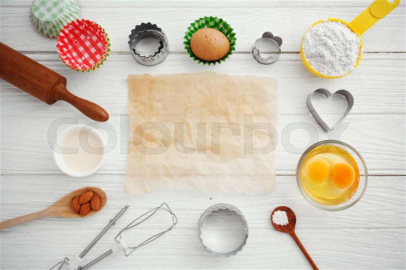 Baking background with baking paper and ingredients, stock photo