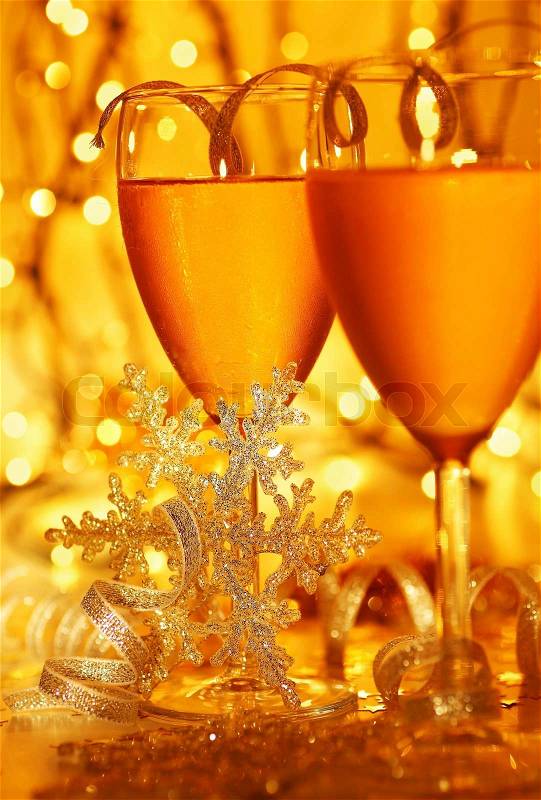 Romantic holiday drink, celebration of Christmas or new year eve, party with Champagne and festive gold ornament lights decoration, stock photo
