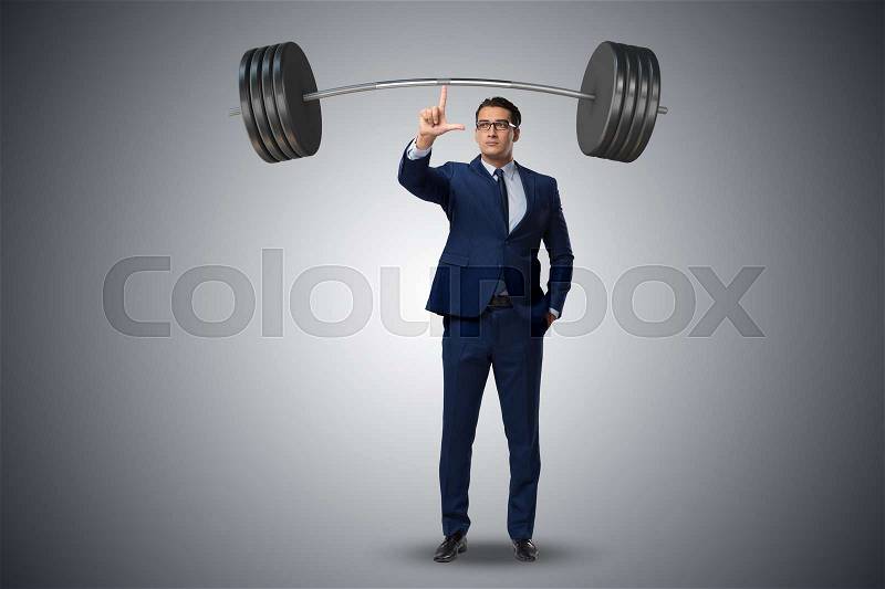 Businessman with barbell in heavy lifting concept, stock photo
