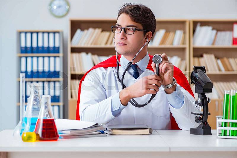 Superhero doctor working in the hospital lab, stock photo