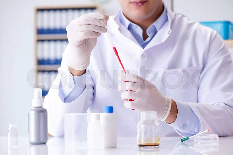 Blood testing in the lab with young scientist, stock photo