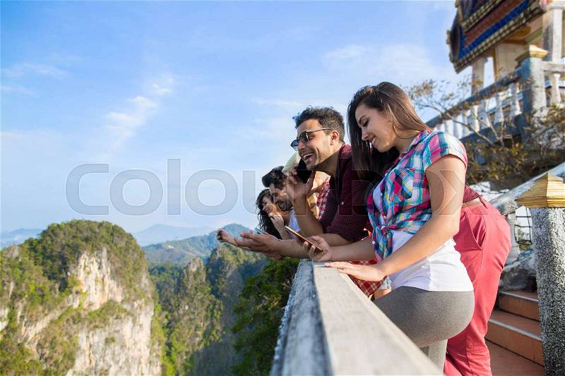 Young People Group In Mountain Using Cell Smart Phone Chatting Online Friends Asian Holiday Summer Vacation Travel, stock photo