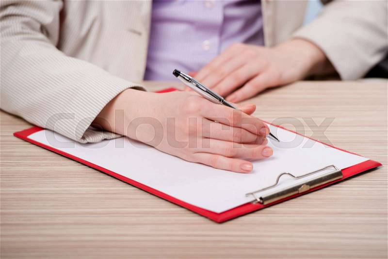 Hands taking notes in the pad, stock photo