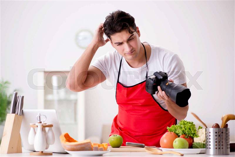 Food blogger working in the kitchen, stock photo