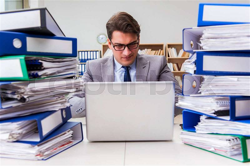 Busy businessman under stress due to excessive work, stock photo