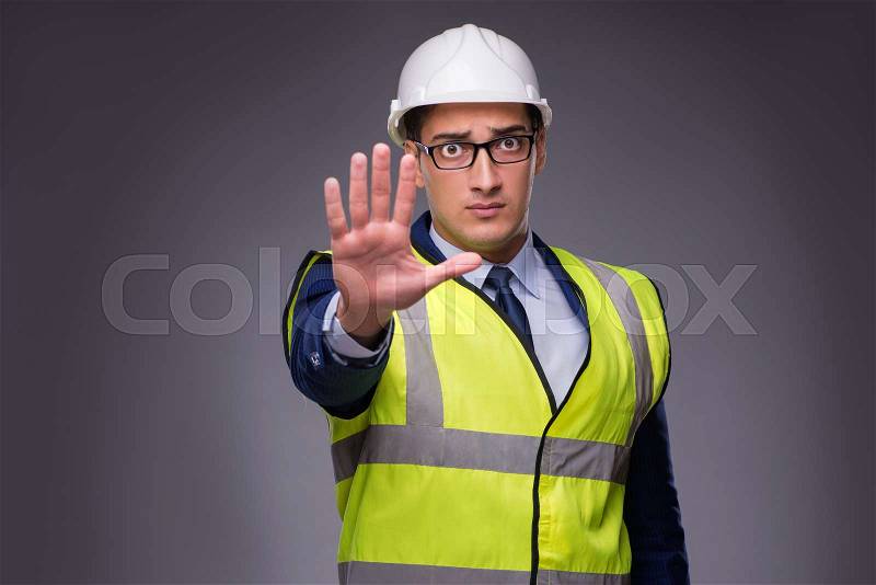 Man wearing hard hat and construction vest, stock photo
