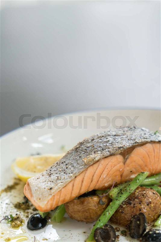 Salmon fish fillet grilled steak on white dish, stock photo