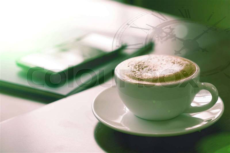 Double exposure of coffee cup with clock face. Cross-Processed, stock photo