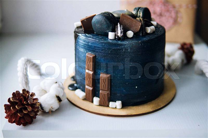 Beautiful designer chocolate cake stands on the table, stock photo