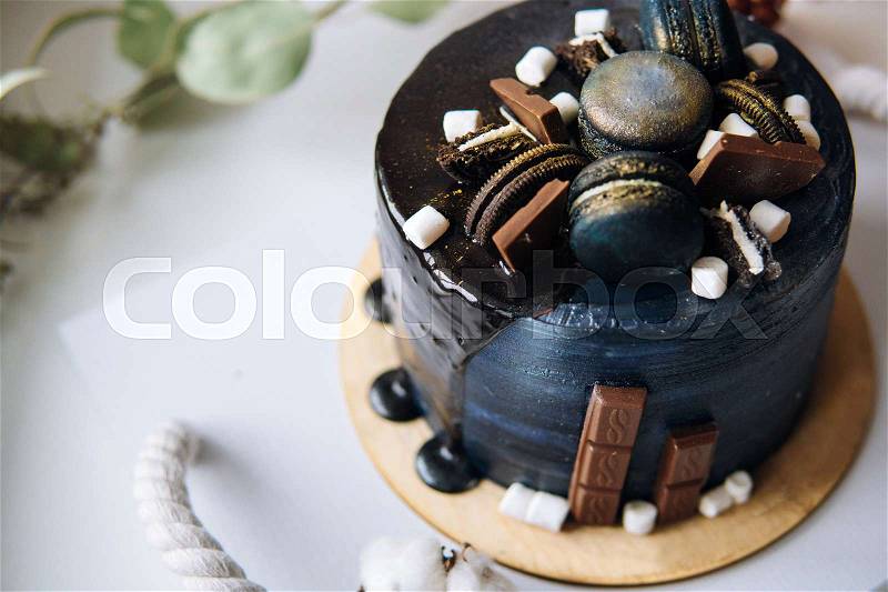 Beautiful designer chocolate cake stands on the table, stock photo