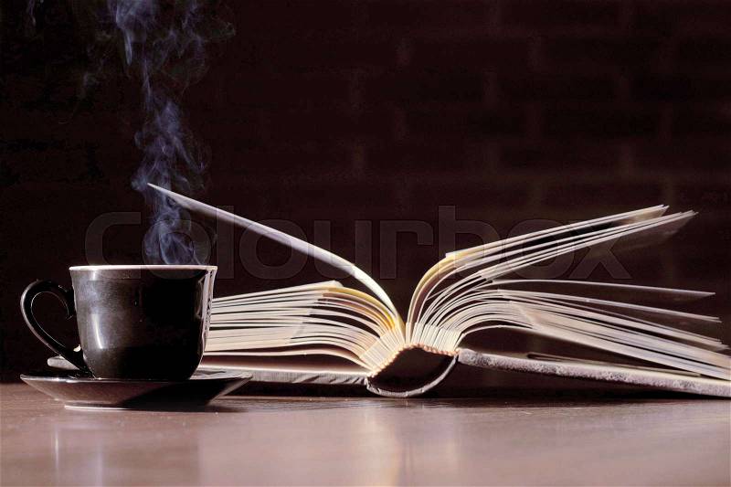 Cup of tea and a book on the table, stock photo