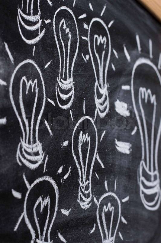 Small ideas make big one sketched drawing on blackboard - vertical image, stock photo