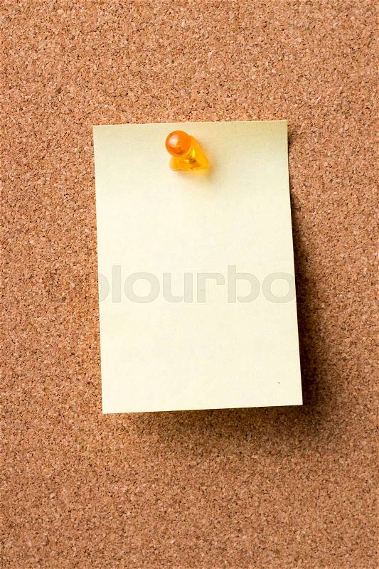 Blank adhesive label pinned on bulletin board - vertical image, stock photo