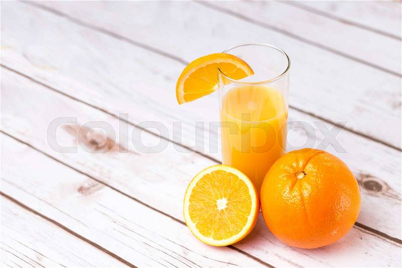 Fresh orange juice in glass with sliced orange - horizontal image, stock photo