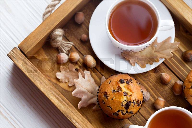 Breakfast - cake and cup of tea on a wooden tray , stock photo