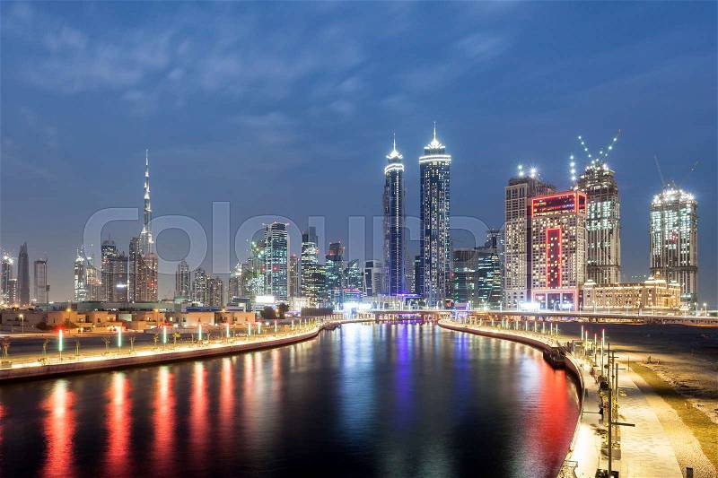 Panoramic view over the Dubai Water Canal and Downtown Skyline illuminated at night. United Arab Emirates, Middle East, stock photo