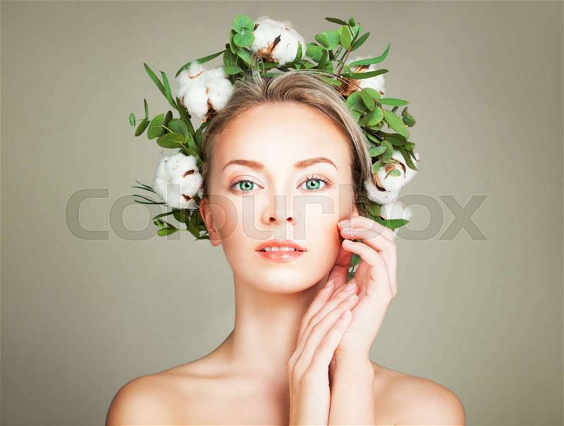 Beautiful Woman with Wreath of Organic Leaves and Cotton Flowers. Spa Model with Nude Makeup, Face Closeup, stock photo