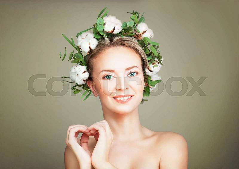Spa Model Woman with Healthy Skin and Cotton Flowers Wreath making a Heart. Spa Beauty, Facial Treatment and Cosmetology Concept, stock photo