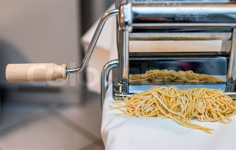 Simple homemade noodles and pasta machine, stock photo