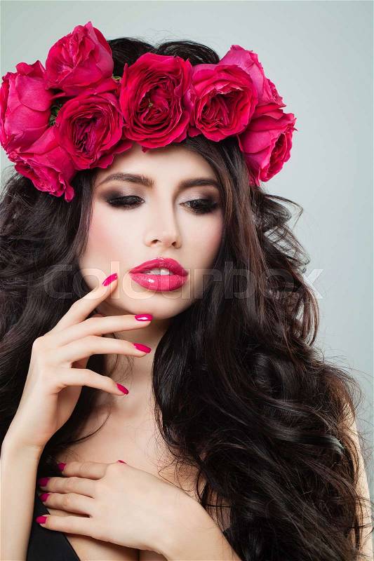 Glamorous Brunette Woman with Curly Hair, Makeup and Summer Flower, stock photo