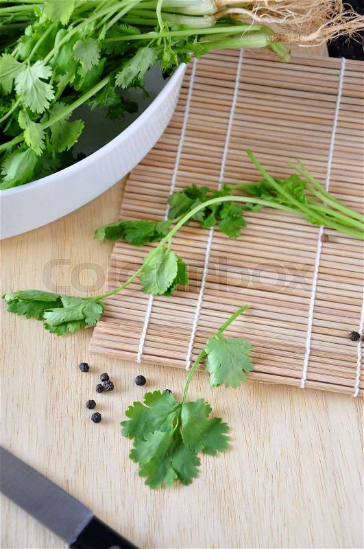 Top view of Coriander leaves on bamboo mat, stock photo