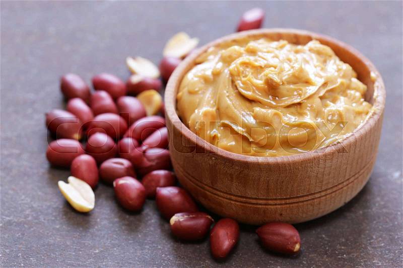 Natural peanut butter with fresh nuts, stock photo